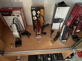 many different types of hair dryers on a shelf