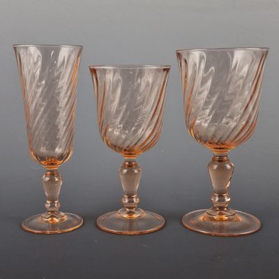 three glass goblets sitting on top of a table next to each other