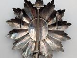 a silver brooch with a flower design on it