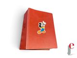 mickey mouse pin on a red book on a white surface