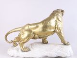 statue of a golden lion on a rock on a white background