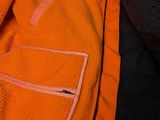 an orange jacket with a picture of a woman on it