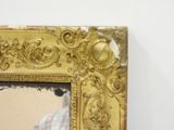 a gold frame with a picture of a man in a white shirt