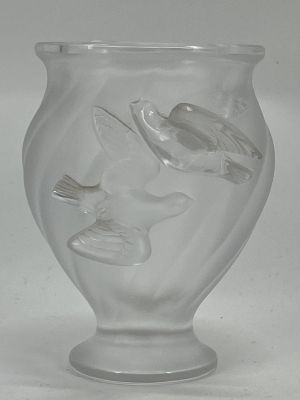 a clear glass vase with a bird design on it