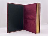 an open book with a red cover and a black cover