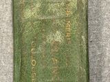 an old green book sitting on top of a gray cloth
