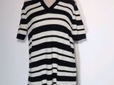 a black and white striped dress on a mannequin stand