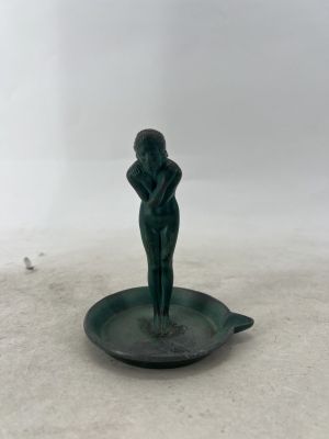 a statue of a woman sitting on a plate