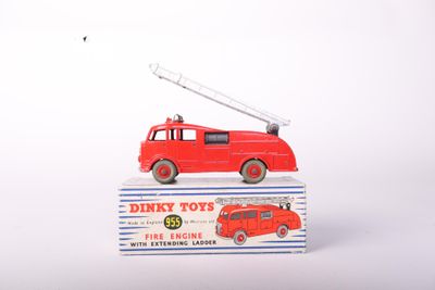 a red toy fire truck with a ladder on top of it