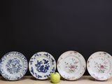 five plates with different designs on them sitting on a table