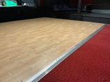 a wooden floor with a red carpet in a room