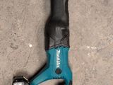 a close up of a cordless tool laying on the ground