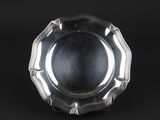 a silver plate on a black background with a black background