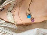 a woman that has a necklace on her stomach
