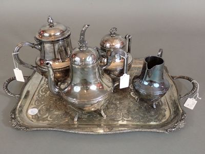 a silver tray with a silver tea set on it