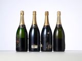 three bottles of champagne sitting next to each other on a table