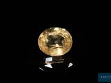 a yellow diamond on a black surface