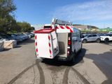 a white utility truck parked in a parking lot