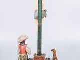 statue of a man on a cross with a dog and a cat