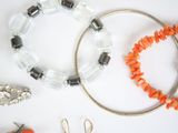 several different types of jewelry laid out on a white surface