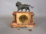 a statue of a lion standing on top of a clock