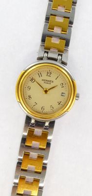 an image of a close up of a wrist watch on a white surface