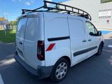 the white van is parked in the parking lot with its roof rack on