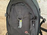 a black backpack that is sitting on the ground