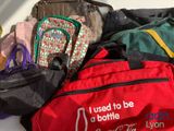 many bags that are sitting on a table together