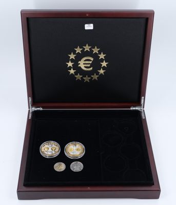 two euro coins in a wooden box with gold stars