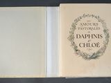 an open book with a picture of a wreath on the cover