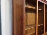 a large wooden bookcase with many shelves in it