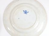 a white plate with a blue design on it