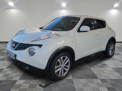the white nissan juke suv is parked on a checkered floor