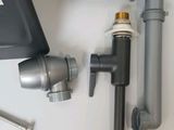 a sink faucet that is next to a faucet that is connected to it