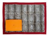 a close up of a leopard print bag with an orange box