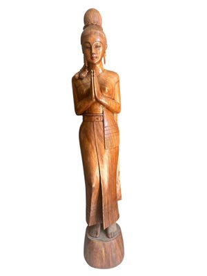 wooden statue of a woman with her hands folded in prayer