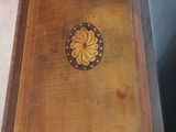 a small wooden table with a decorative design on it
