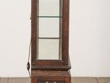 a small display cabinet with a glass door in the middle