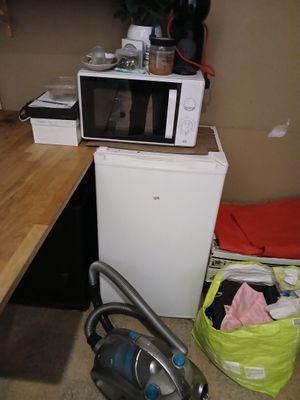 une petite cuisine équipée d'un micro-ondes et d'un lave-linge
