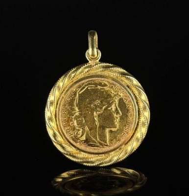 a gold coin with a woman ' s face in the center