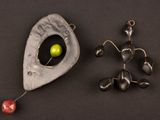 a small metal object with a green apple in it