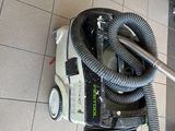 a vacuum that is sitting on the floor in the bathroom
