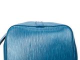 a close up of a blue toilet bag on a white background