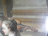 un tableau représentant une femme jouant du violon et un homme lisant un livre