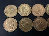 six different types of coins are shown on a black surface