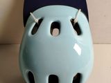 a blue helmet with holes on the front of it