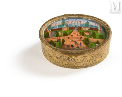 a small gold box with a picture of a city on it