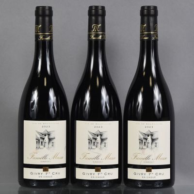 three bottles of wine are lined up on a table