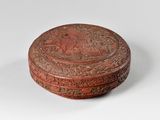 une vieille boîte rouge avec un motif sur le couvercle